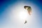 paraglider flying with paramotor on blue sky