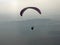 Paraglider flying wing on a misty morning