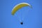 Paraglider flying yellow wing