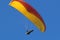 Paraglider flying yellow wing