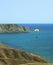 Paraglider glides over sea