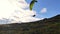 Paraglider on green paragliding wing take of in summer mountain adrenaline adventure