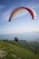 Paraglider jumps from the mountain to the sea, blue sky, warm breeze, a parachute,