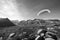 Paraglider Pilot stands on a slope and balances his paraglider above his head in the Alps of Switzerland