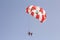 Paraglider with a saddle for people. Parasales - water parachutes. Bright colours