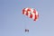 Paraglider with a saddle for people. Parasales - water parachutes. Bright colours