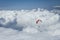 Paraglider silhouett against a cloudy blue sky