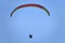 Paraglider silhouette flying in the blue sky