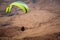 A paraglider soars over the Israeli desert