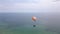 A paraglider soars over the sea and forest with a breathtaking view of the resort town of Albena in Bulgaria, creating