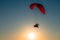 A paraglider soars in the sky