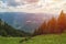 Paraglider taking off in front of spectacular mountain scenery