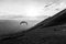 A paraglider taking off from Monte Cucco Umbria, Italy,at almost sunset, with people watching