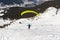 Paraglider taking off from a snowy alpine slope