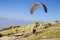Paraglider tandem running on cliff to take off mountain summit