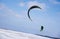 Paragliders in blue sky winter over frozen river. Snow Kiting. Winter sports. Sloping horizon