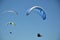 Paragliders in flight in blue sky