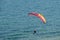 Paragliders fly along the steep coast of the Baltic Sea