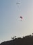 Paragliders flying in blue sky