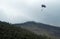 Paragliders gliding down a mountain a mountain