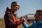 Paragliders high fiving after walking up hill to paragliding starting point, on a sunny morning in mountains.