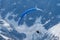 Paragliders looking for thermals amongst the snow caps of the Monte Blanc Massif, Chamonix,