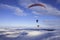 Paragliders over Ingleborough mountain in the snow