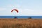 Paragliders tandem at the start, sky divers training by the sea shore