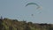 Paragliding against clear blue sky