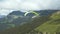 Paragliding in the Alps mountains. Paraglider fly with parachute high in sky.