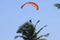 Paragliding athlete flies quietly under the sunny weather