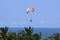 Paragliding athlete flies quietly under the sunny weather