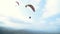 Paragliding flight against blue sky and mountain