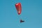 Paragliding flying over blue sky