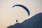 Paragliding in Oludeniz. Paraglider, airborne against blue sky.