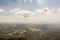 Paragliding over green hilly landscape