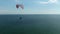 Paragliding over the sea, beautiful view on the sea reflecting the sunlight