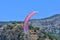 Paragliding. Paraglider on a blue sky and mountains background