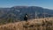 Paragliding pilot is preparing for flight in mountains.