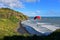 Paragliding at scenic Muriwai Beach