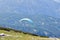 Paragliding in the sky. Paraglider flying over the sky with blue water and mountains in bright sunny day