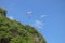 Paragliding in the sky. Three single paragliders flying in summer day over tropical Bali island. Beautiful paraglider in flight on