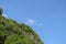 Paragliding in the sky. Three single paragliders flying in summer day over tropical Bali island. Beautiful paraglider in flight on