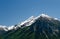 Paragliding in the Swiss Alps above snow covered peaks