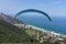Paragliding takeoff to fly over the beach next to mountains