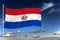 Paraguai national flag waving in the wind against deep blue sky.  International relations concept