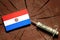 Paraguay flag on a stump with syringe injecting money