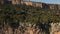 Parallax effect, aerial view from drone on amazing limestone cliff rocky wall and mountains on background.