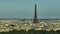 Parallax effect. Close-up shot of the Eiffel tower on a drone from a height. Aerial Panorama of Paris Cityscape