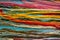 Parallel colorful cotton embroidery floss background, threads for needle craft close up